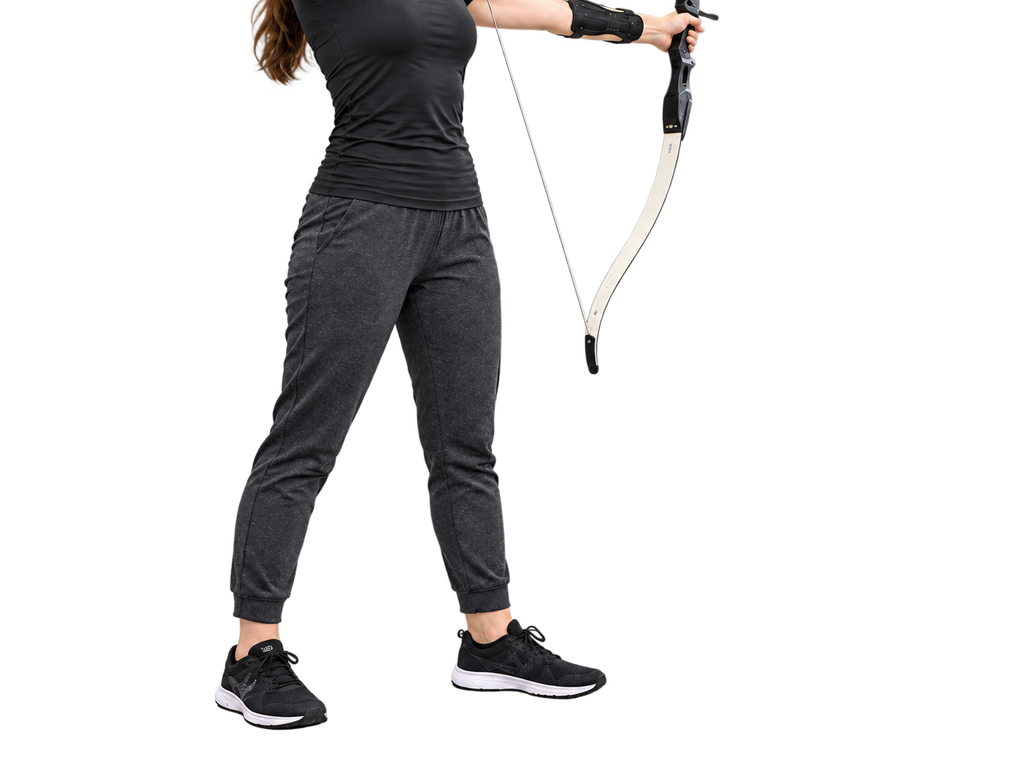 An archer standing square to the target on the shooting line in flat athletic shoes.